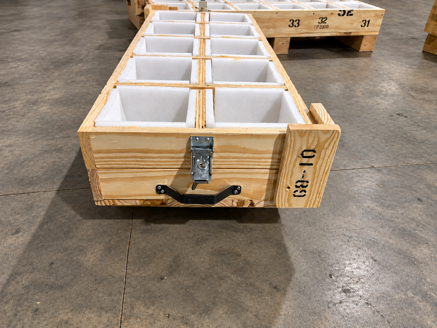 Custom foam-lined wooden specialty crate with compartments, latch and carrying handle